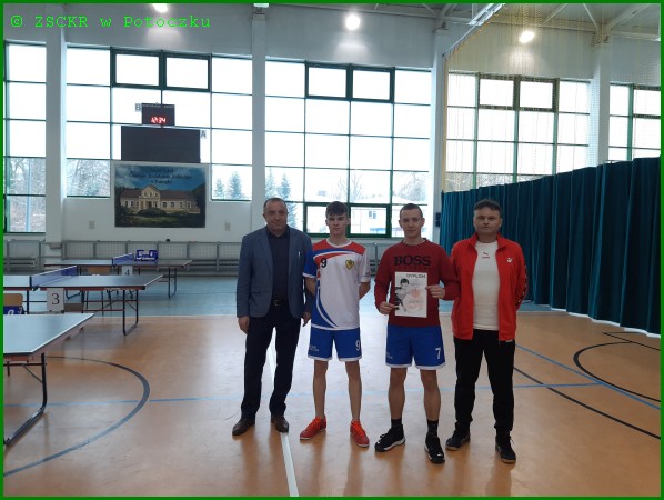  Dyrektor Dariusz Wolan (pierwszy z lewej) i nauczyciel wf Mariusz Karkusiewicz (pierwszy z prawej) z drużyną chłopców ZSCKR w Potoczku podczas ceremonii wręczenia dyplomu za zajęcie II m -Powiatowa Licealiada w drużynowym tenisie stołowym - Potoczek 07.02.2023 r 